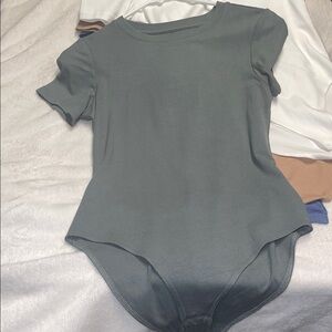 Five body suits T-shirt material very soft brand new never worn
